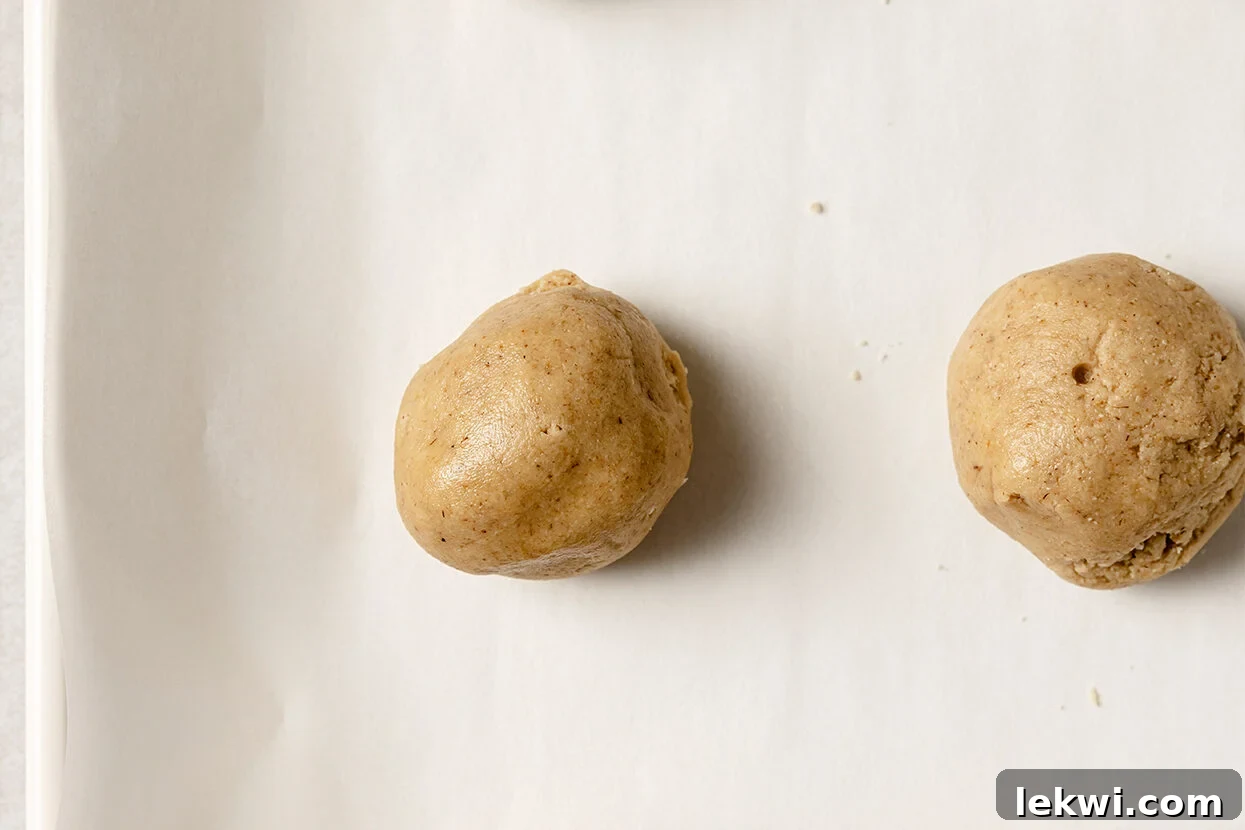Small, uniform balls of snickerdoodle dough ready for coating.
