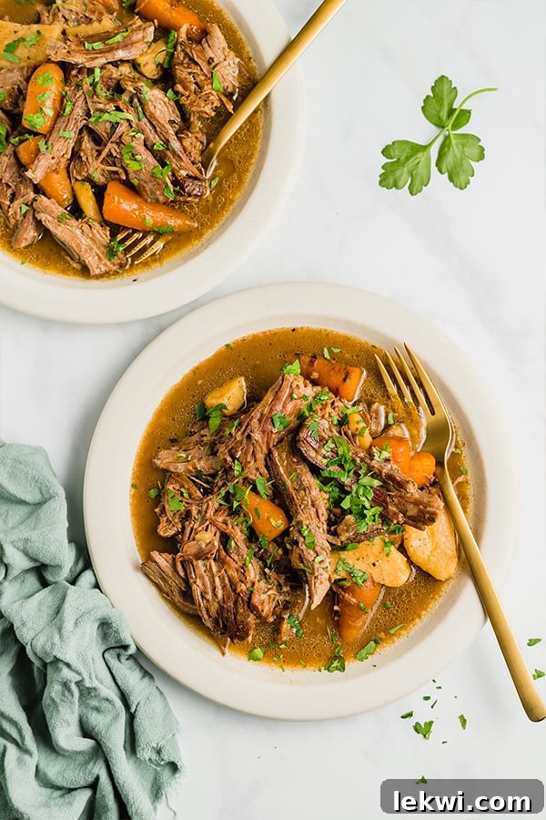 slow cooker pot roast in bowls with forks