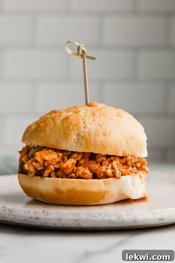 Turkey sloppy joe in between two bread slices with a toothpick in the middle, served as a sandwich.