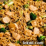 Chicken and broccoli ramen in a pan, still in the cooking process.