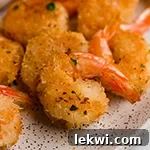 Oven baked coconut shrimp on a plate.