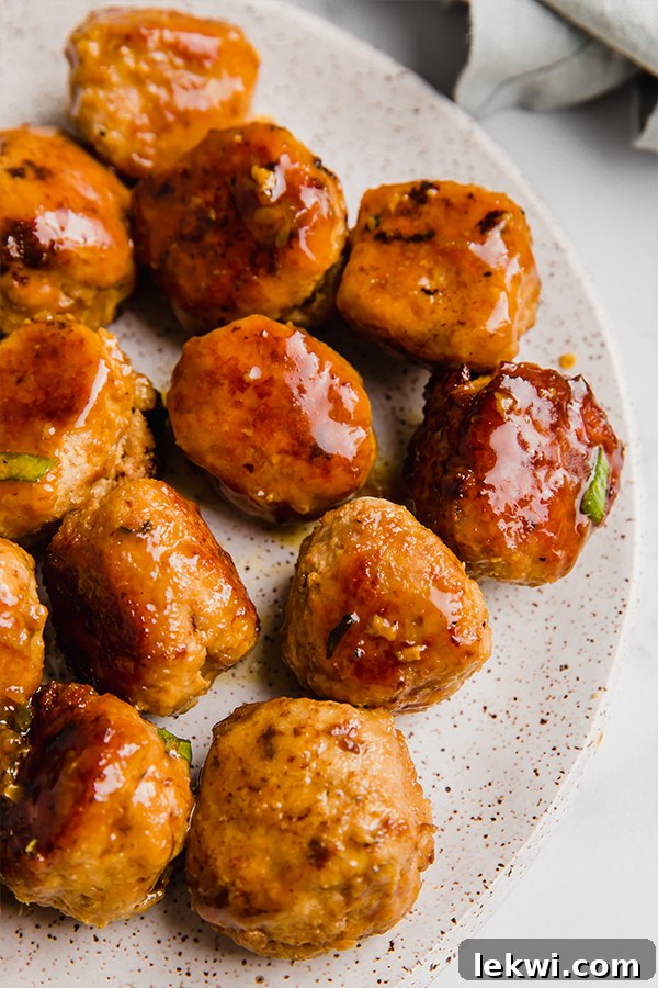 Teriyaki turkey meatballs arranged neatly on a plate, ready to be enjoyed.
