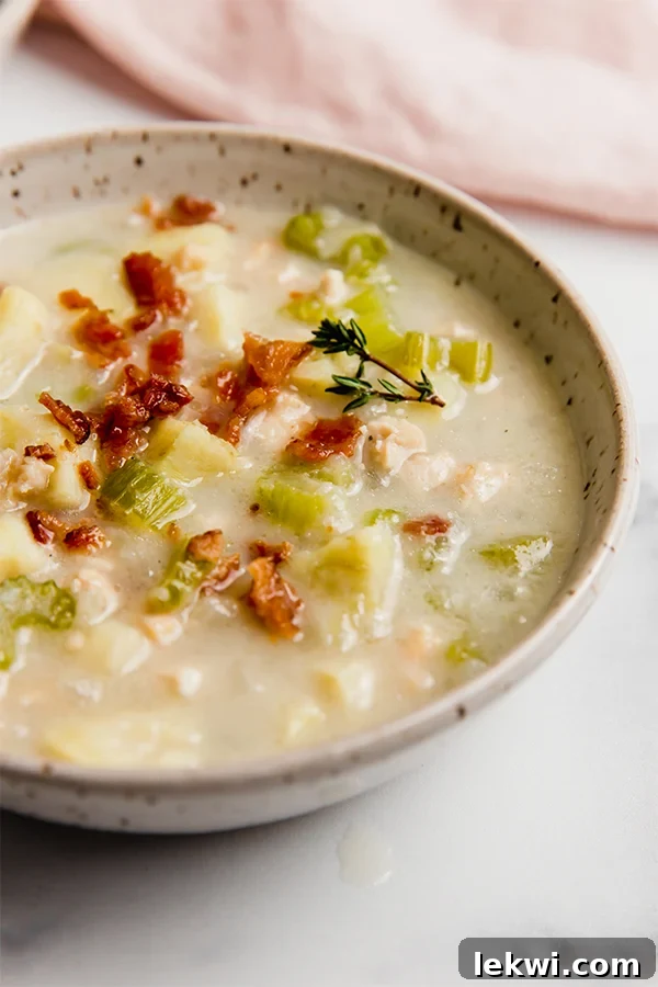 A bowl of creamy clam chowder, ready to be enjoyed.