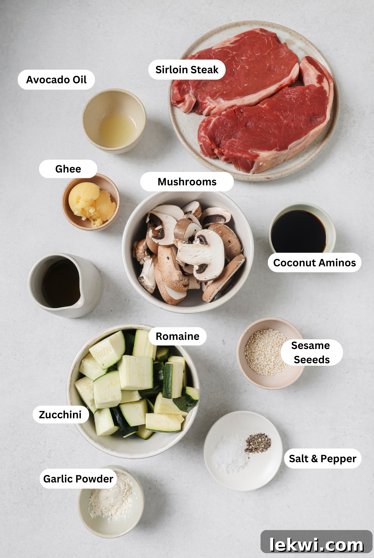 All the fresh ingredients laid out for making hibachi steak bites with vegetables, including sirloin steak, zucchini, mushrooms, and various seasonings.