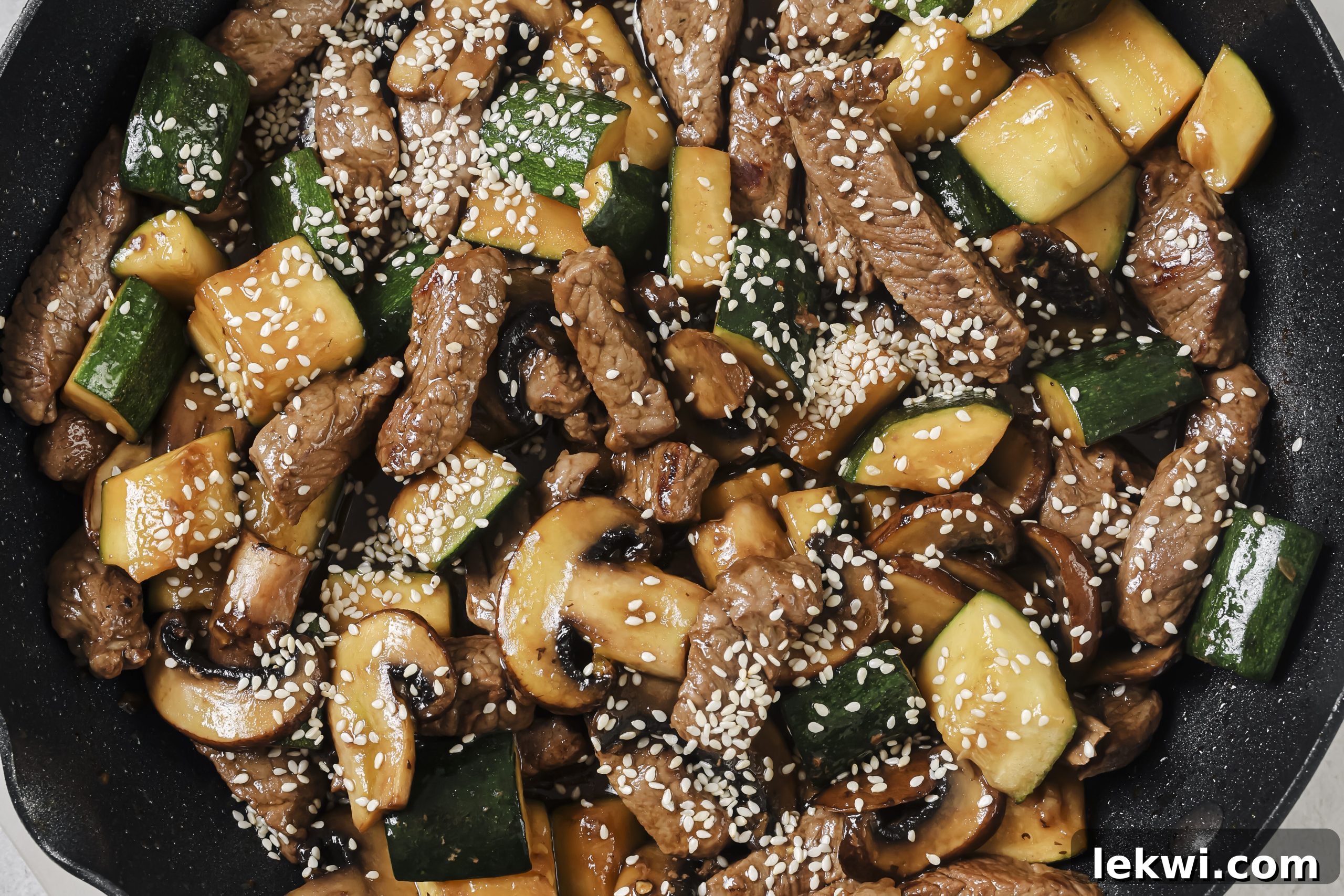 The finished one-pan hibachi dish, with perfectly cooked steak bites and tender vegetables combined in a black pan, ready to be served.
