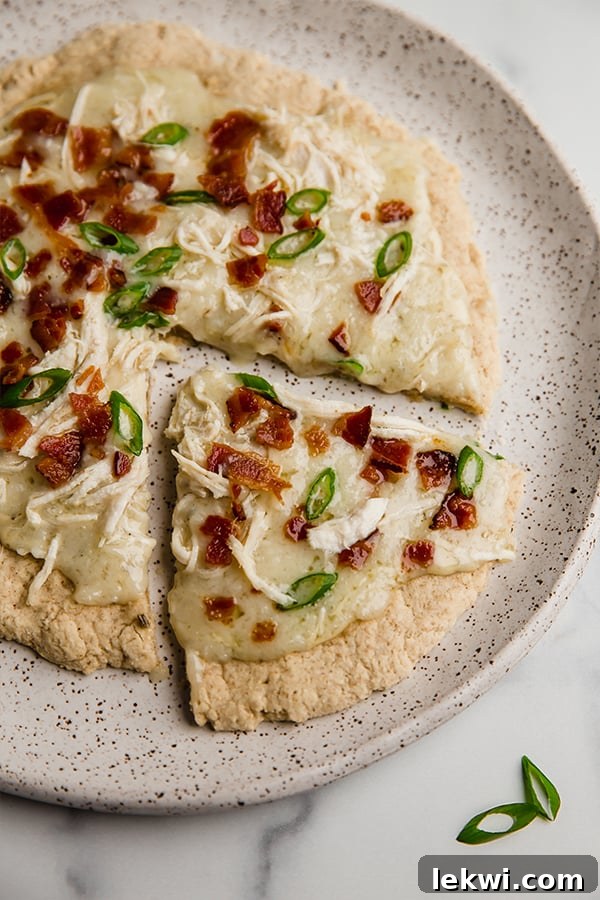 Bacon ranch chicken pizza topped with bacon and green onion