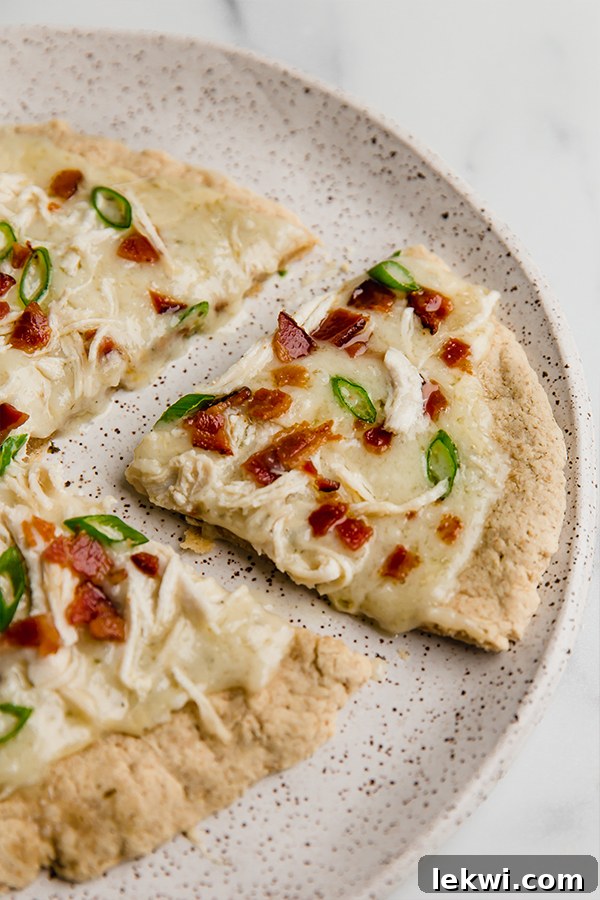 bacon ranch pizza on plate with slice