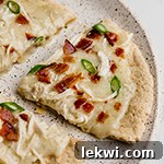 Bacon ranch chicken pizza topped with bacon and green onion
