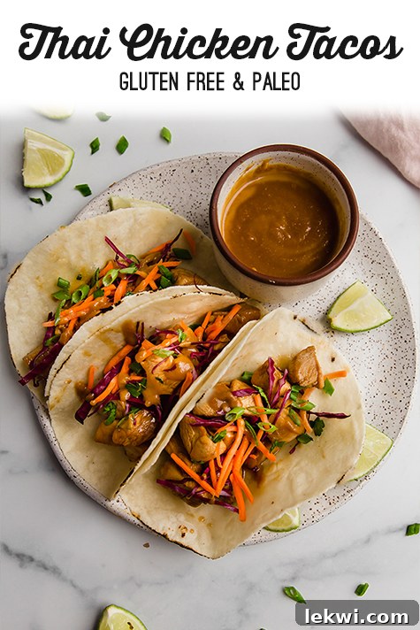 A visually appealing Pinterest graphic featuring three Thai chicken tacos with vibrant fillings and sauce on a plate, perfect for sharing on social media.