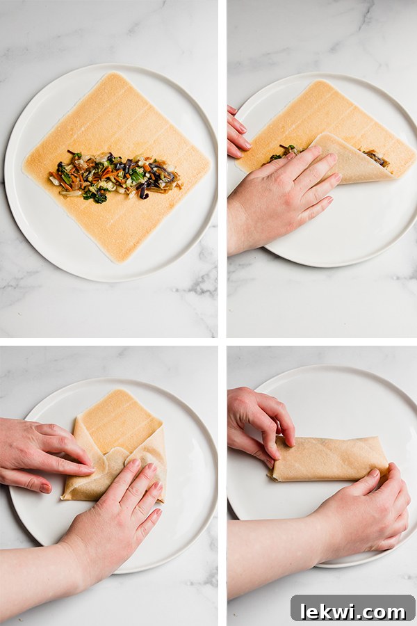 egg roll being rolled with filling inside