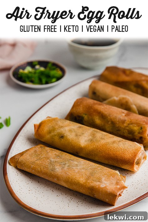 A platter of cooked air fryer egg rolls, garnished and ready for serving.