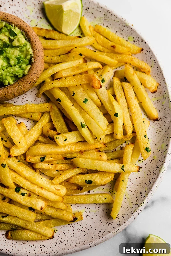 A neatly arranged plate of crispy jicama fries, showcasing their golden texture, ready to be served as a healthy snack or side dish.