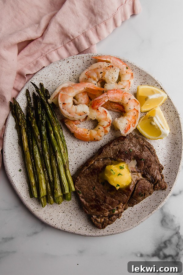 Another view of the delicious surf and turf skillet on a plate, highlighting the perfectly cooked steak and shrimp.