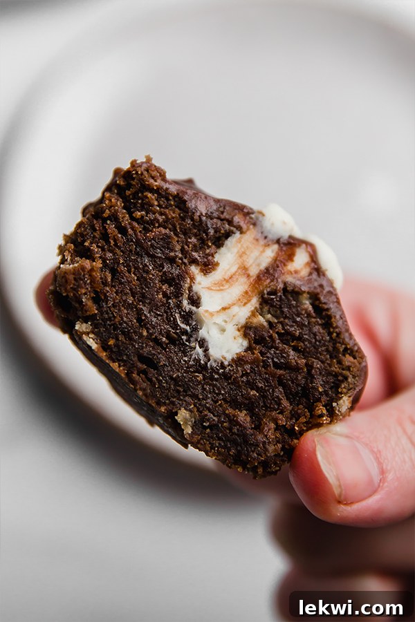 half of ding dong cupcake in hand