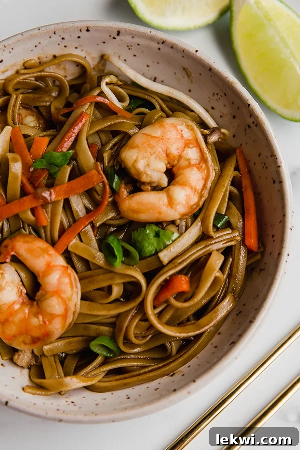 Shrimp in a bowl of gluten-free Pad Thai.