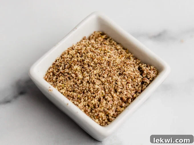 A small bowl containing a viscous mixture of ground flaxseed and water, prepared as a flax egg substitute.
