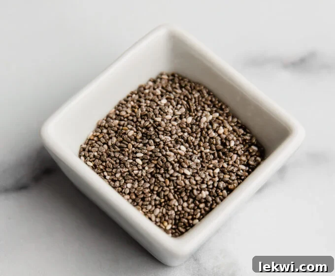 A small bowl with chia seeds mixed in water, forming a gel, ready to be used as a chia egg substitute.