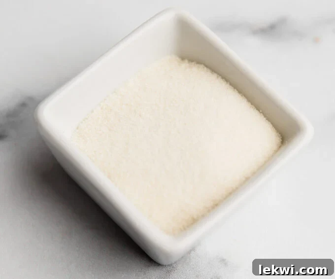 A bowl containing gelatin granules, prepared to be mixed with water for a gelatin egg substitute.
