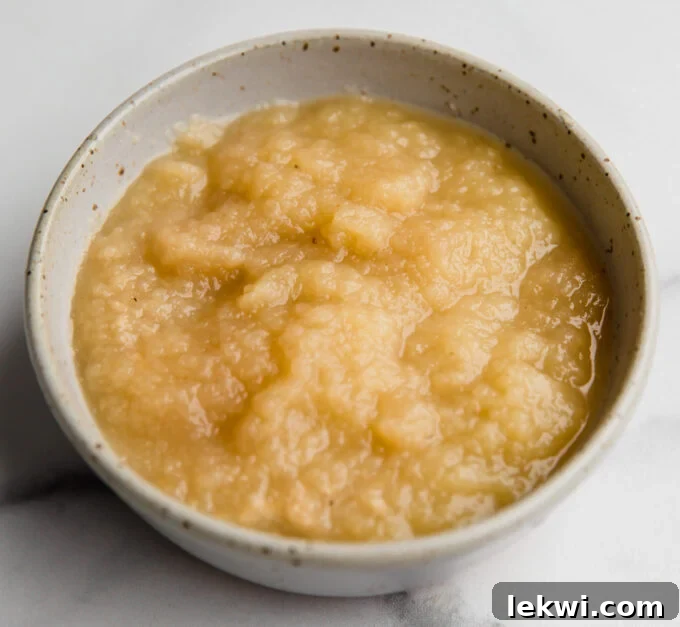 A bowl of smooth applesauce, a natural and effective egg substitute for baking.