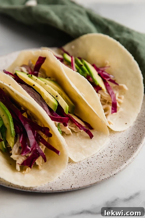 Delicious slow cooker cilantro lime chicken tacos served on warm tortillas with fresh toppings.