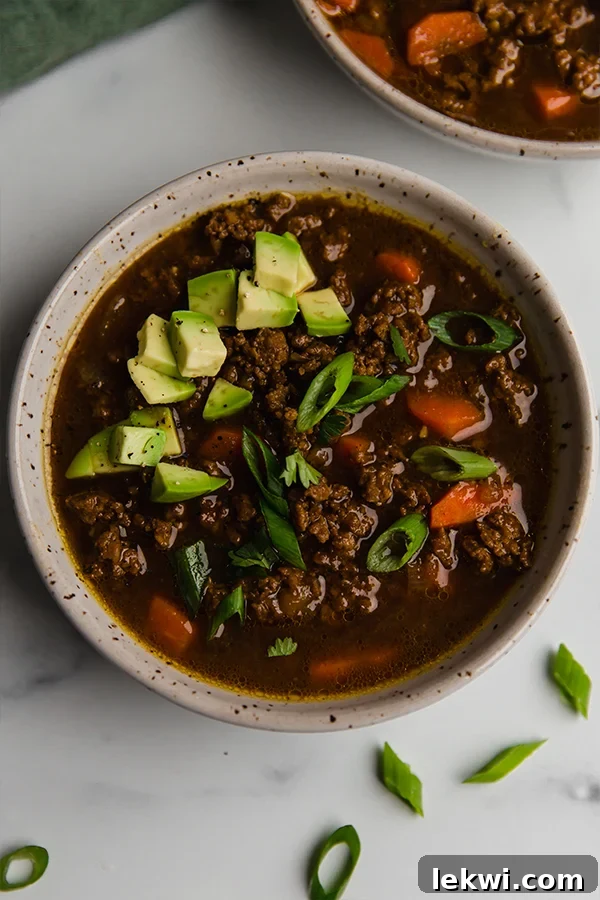 A second view of the Asian inspired chili in a serving bowl, highlighting its rich texture and color.