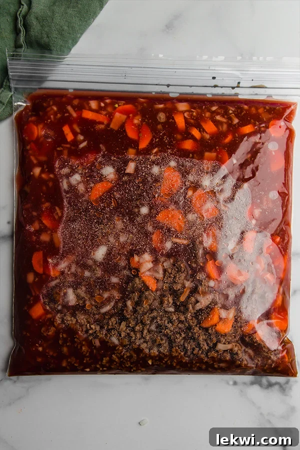 Asian Inspired Chili stored in a clear freezer bag, ready for future meal prep.