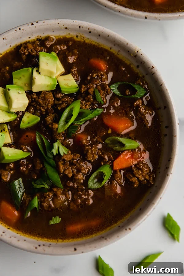 Asian chili topped with avocado in a bowl.
