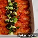 Chicken enchiladas in a baking dish.
