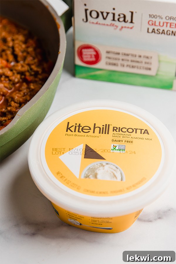 A container of Kite Hill dairy-free almond ricotta cheese, highlighted as a key ingredient for the roll-ups.