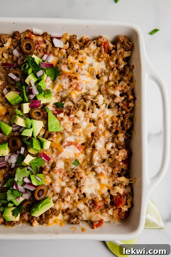 Taco casserole in a baking dish, garnished and ready to serve.