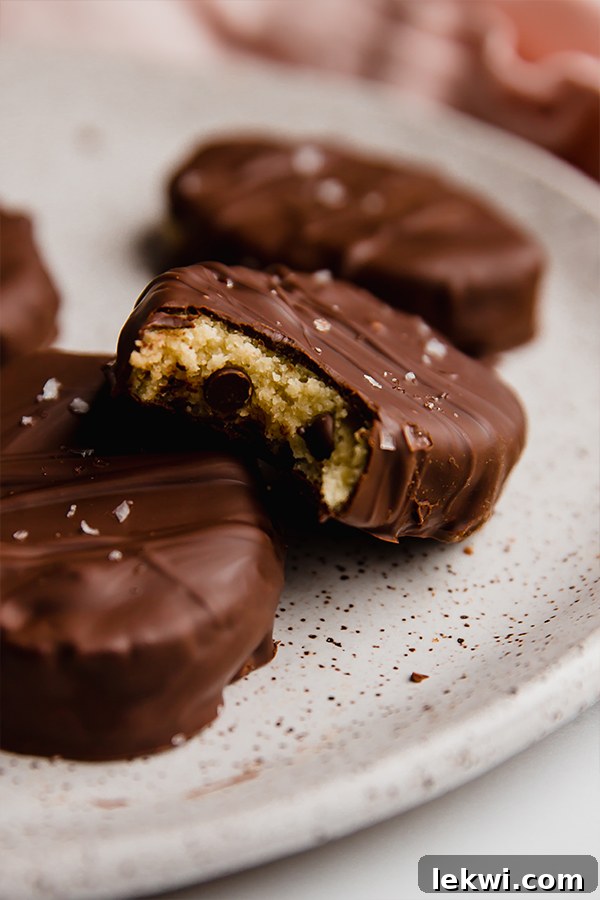 A delicious chocolate covered cookie dough Easter egg with a bite taken out, revealing the edible cookie dough inside.