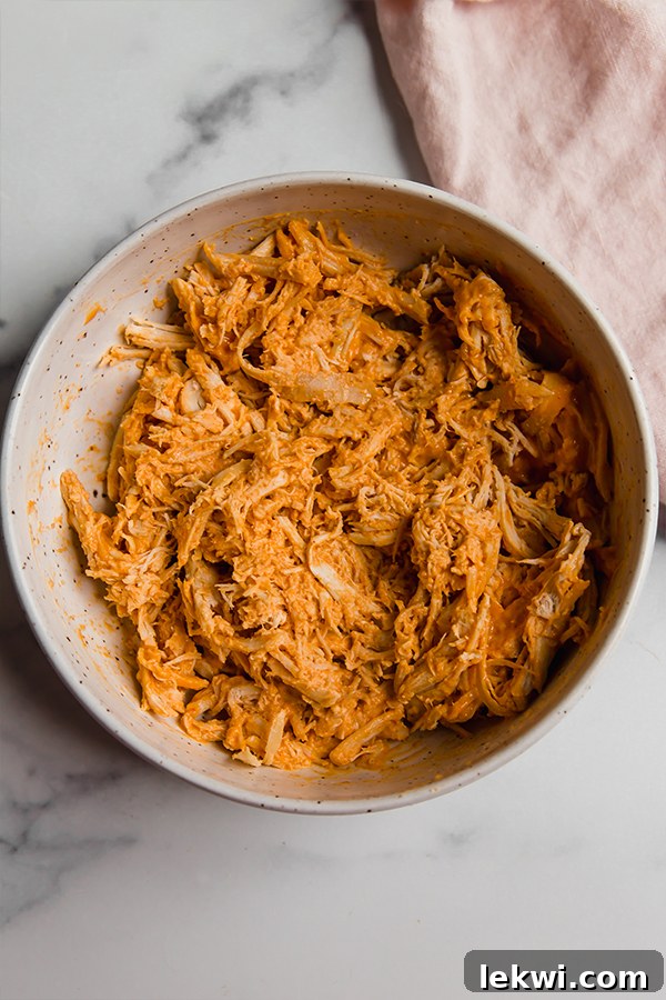 Buffalo chicken mixed thoroughly in a bowl, ready to be stuffed.
