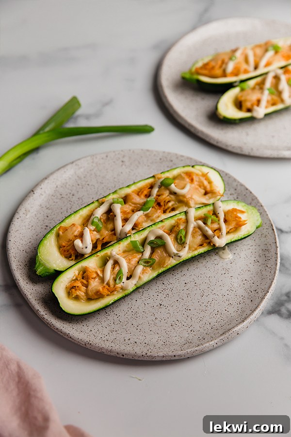 Stuffed zucchini boats plated individually, ready to be enjoyed.