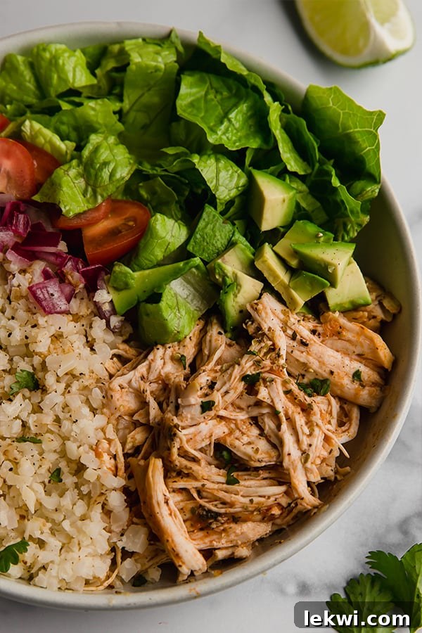 Vibrant Instant Pot Chicken Burrito Bowl served with fresh toppings on a rustic counter, highlighting a healthy, quick meal solution.