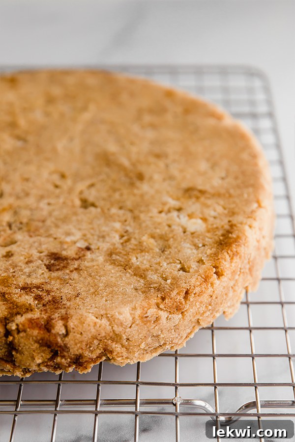 A freshly baked coconut flour lemon banana cake cooling on a wire rack, steam gently rising.