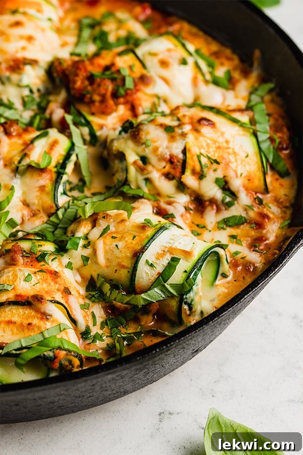 Zucchini roll ups topped with melted dairy-free cheese.