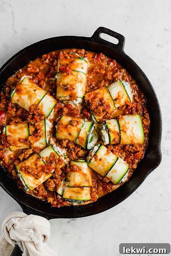 Top view of zucchini roll ups in cast iron pan on counter