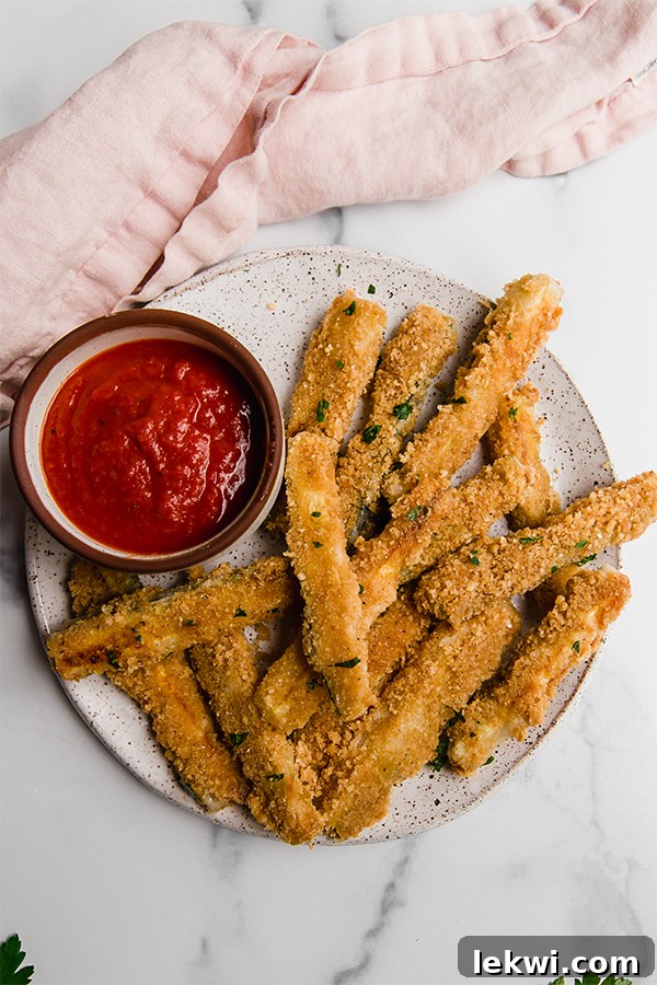Crispy Pork Panko Zucchini Fries AIP Paleo Egg Free 3 Baked zucchini fries coated in pork panko, served alongside marinara sauce for dipping.