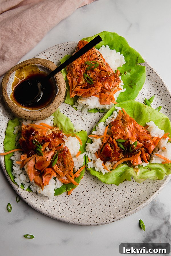 Beautifully plated salmon lettuce cups with a side of teriyaki sauce, ready to be enjoyed.