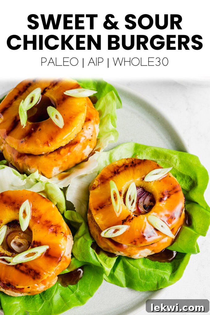 This visually appealing image features two gourmet "Sweet & Sour Chicken Burgers" with text overlays highlighting their dietary benefits: "Paleo | AIP | Whole30." The burgers are artfully arranged, promising a healthy and delicious meal.