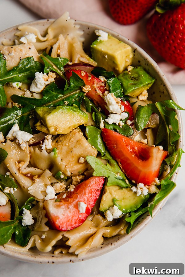 A bowl of fresh Strawberry Balsamic Pasta Salad, ready to be enjoyed.