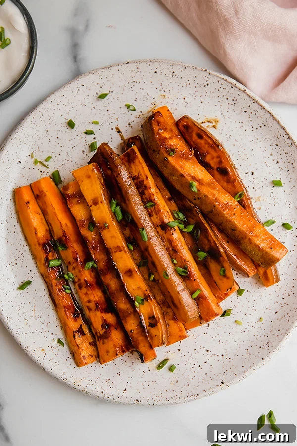 Grilled sweet potato fries piled on a plate, ready to serve and enjoy.
