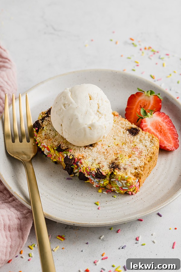 Plate with a slice of ice cream bread topped with fresh strawberries, ready to be enjoyed.