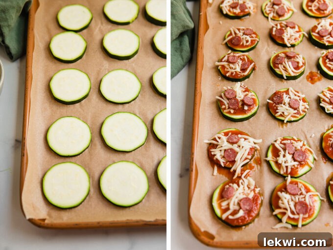Sliced zucchini arranged on a baking sheet, topped with marinara sauce and cheese, ready for the oven.