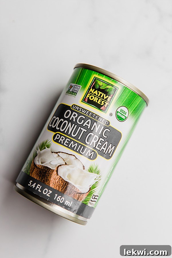 A high-quality can of Native Forest Unsweetened Organic Coconut Cream, a primary ingredient for this quick coconut milk method.