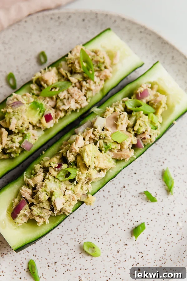 Avocado tuna salad cucumber boats on a plate, ready to be enjoyed.