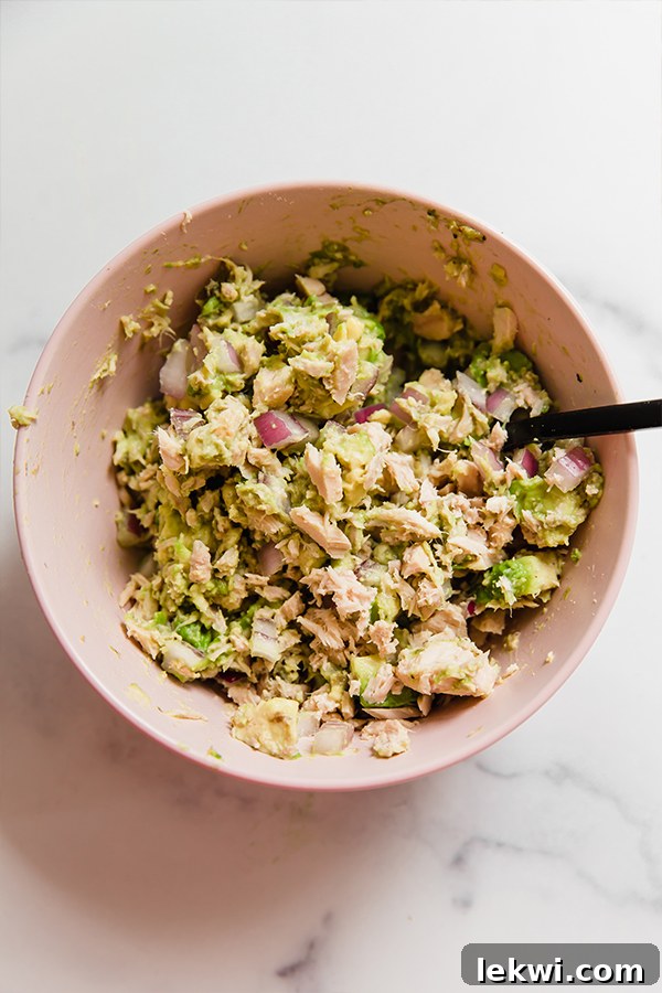 Creamy avocado tuna salad in a bowl, perfectly mixed.