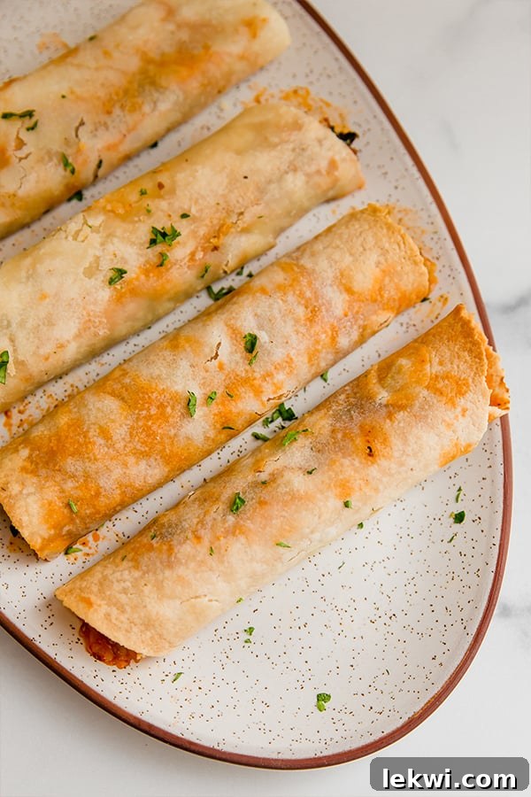 Cooked gluten-free pizza taquitos served attractively on a platter.