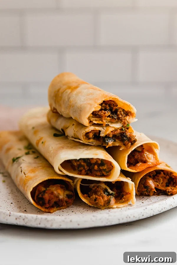 Gluten-free pizza roll ups stacked on a plate.