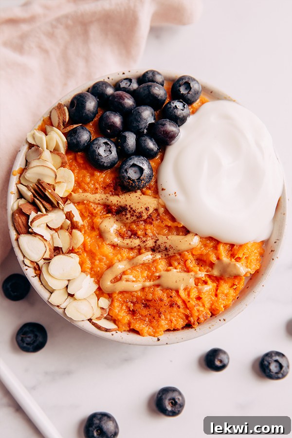 Top view of a delightful sweet potato bowl with various toppings on a kitchen counter.
